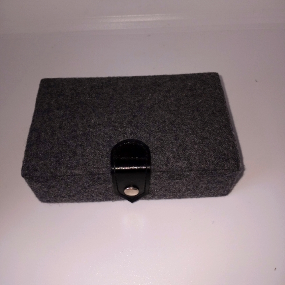 Mini gray jewelry box with snap button closure